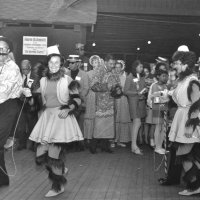 May 1968 - District 4C-4 Convention, Hoberg’s Resort, Lake County - Costume Parade - A member & wife, followed closely by Estelle & Charlie Bottarini wander through the crowd after the costume parade and Lions and others look on.