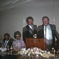 6/17/78 - Installation of Officers, Ramada Inn, S.F. Airport, Millbrae - L to R: Trudy & Leonardo Bacci, Emily & Joe Farrah, and Ervin Smith. Erv Smith accepting his Past President’s Plaque. (Sorry for the double exposure.)