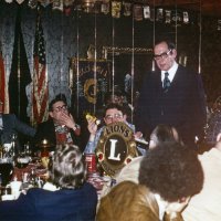 3/14/79 - Regular Meeting, L & L Castle Lanes, San Francisco - L to R, head table left: Ed Damonte, Jerry Ennis, Handford Clews, Dr. Irwin Schwab, and Charles Grisenti (partial). Dr. Schwab, an Ophthalmologist resident at the Pacific Medical Center, acknowledged Lions for their support of the Center through contributions of dollars and equipment through the Lions Eye Foundation and by patient referrals. Dr.Schwab showed slides and discussed “Eye Care in the Third World”. Charles Grisenti, and Bill Cazatt (not shown), were inducted as new members in this meeting by District Governor George Habeeb.