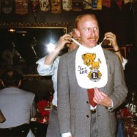 5/11/83 - New Member Induction, L & L Castle Lanes, San Francisco - Jim Kerr - Dick Johnson, left, watches as Les Doran gives his Baby Lion bib to newly inducted Lion Jim Kerr.