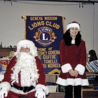 12-20-02 - Mission Education Center Christmas with Santa, Mission Education Center, San Francisco - Santa and his lovely assistant stop to pose.