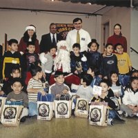 12-20-02 - Mission Education Center Christmas with Santa, Mission Education Center, San Francisco - A class, their teacher, and Dr. Mehendra Dave, 2nd from left in back row, and Sheriar Irani, to his right, pose with Santa and his assistant after receiving their gifts.