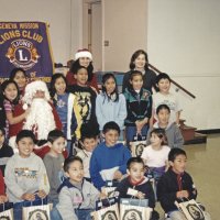 12-20-02 - Mission Education Center Christmas with Santa, Mission Education Center, San Francisco - A class happly poses with Santa and his assistant after receiving their gifts.