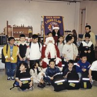 12-20-02 - Mission Education Center Christmas with Santa, Mission Education Center, San Francisco - A class tries to settle down and have their picture taken with Santa, his assistant, and their teacher.