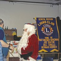 12-20-02 - Mission Education Center Christmas with Santa, Mission Education Center, San Francisco - Aaron Straus, teal shirt, going over present details with Santa as Al Gentile, left, and Sheriar Irani, right, look on. Steve Currier is in the background.