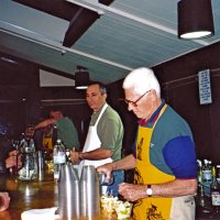 2/26/05 - Recreation Center For the Handicapped, San Francisco - 23rd Annual Crab Feed - 429 attending - Guests being served at the open bar before dinner. Opposite end of bar serving is Charlie Bottarini, Mark Ramezzano, guest helper, and Al Gentile.