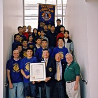 12/15/04 - Lowell Leo Club - Leo members displaying their Club Charter. District Governor Eugene Chan is holding the charter, with Al Russell and Bob Lawhon on his left.