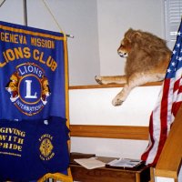 6/30/05 - Lowell Leo Club - The Leo Club mascot taking it easy with the Geneva-Mission banner.