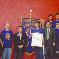 12/15/04 - Lowell Leo Club - Leo members displaying their Club Charter. Al Russell on far left with District Governor Eugene Chan next to banner. Bob Lawhon is just right of the banner in the back.