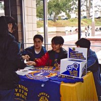 3/4/05 - Lowell Leo Club - Members of the Leos display Leo and Lions information at a fair at their school while discussing membership with an other student.