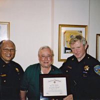 8/14/04 - An unidentified Police Officer, Bob Lawhon, and Captain Paul Chignell. Bob Lawhon is presenting Capt. Chignell with a Certificate of Appreciation in connection with the Police & Firefighters Awards.
