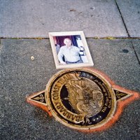 6/8/05 - The recently installed Giulio Francesconi “Barbary Coast Trail” memorial plaque on Washington Square's sidewalk opposite Moose's Restaurant with a photo of the late Giulio Francesconi.