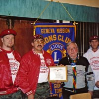 1/19/05 - Granada Cafe -  Our guest speakers, the Guardian Angels, which are a volunteer organization committed to the safety and well being of the community. Shown are a Guardian Angel member, leader Juan Carlos Morales, President Bob Lawhon presenting a Certificate of Appreciation, and another member of the Angels.