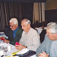 1/19/05 - Granada Cafe -  L to R: Al Gentile, Charlie Bottarini, Joe Farrah, Sheriar Irani, and Aaron Straus (over Joe's shoulder) following our guest speaker's presentation. Al and Charlie have their Crab Feed tickets in hands.