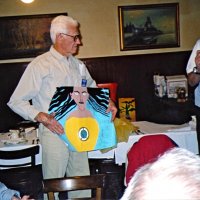 11/10/04 - Granada Cafe - Al Gentile (left) and Aaron Straus  displaying two of our entries in the Peace Poster Contest. The participating schools were Corpus Christi, St. Elizabeth, St. John and Cornerstone Academy. The theme for this year's competition was “Give Peace A Chance.” Seated on left is Bill Graziano.