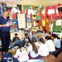 2/17/06 - Flag Day Program at Mission Educational Center for 211 students - Lion Aaron Straus gets close and personal with students while talking about the meaning of the flag and its history. Principal Deborah Molof looks on from the right.