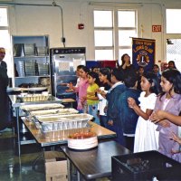 11/22/05 - Mission Educational Center, San Francisco - Lions Sheriar Irani and Aaron Straus, on left, watch while students sing a song.