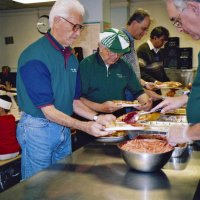 11/22/05 - Mission Educational Center, San Francisco - L to R: Lions Al Gentile, Joe Farrah, Lyle Workman, and Sheriar Irani circling around for another handful of plates to serve while Lion Aaron Straus dishes up cranberry sauce.