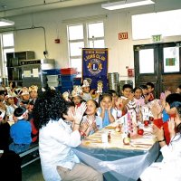 11/22/05 - Mission Educational Center, San Francisco - Another song, just before lunch. Standing, Lion Aaron Straus looks on from the left, while Deborah Molof, principal, looks on from the right.