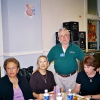 11/22/05 - Mission Educational Center, San Francisco - Lion Bob Lawhon (standing) stopping to pose with principal Deborah Molof (on his left) and visitors.