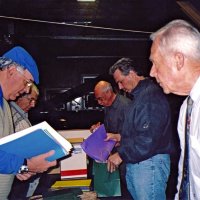 12/15/05 - MEC Christmas at Lion Charlie Bottarini‘s basement on Moscow St. - L to R: Lions Aaron Straus (chairman), Joe Farrah, Bill Graziano, Bob Fenech, and Ward Donnelly stuffing gift bags to be distributed to students at the next day‘s Christmas Party at the Mission Educational Center.