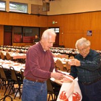 2/23/08 - 26th Annual Crab Feed - Janet Pomeroy Recreation & Rehabilitation Center, San Francisco - With most of setup complete, Ward Donnelly, left, with Joe Farrah place bibs over the table settings. Dick Johnson working in the background.