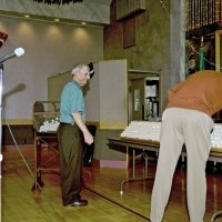 11/29/09 - 31st Annual Guilio Francesconi Charity Raffle drawing, Italian American Social Club, San Francisco - Charlie Bottarini, left, helping Dick Johnson place all the drawing balls into the drum before the drawing.