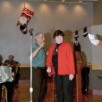 11/29/09 - 31st Annual Guilio Francesconi Charity Raffle drawing, Italian American Social Club, San Francisco - Charlie Bottarini explaining to Margot Clews that her ball is already in the drum. She will later find out she has the grand prize ball.