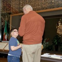 11/29/09 - 31st Annual Guilio Francesconi Charity Raffle drawing, Italian American Social Club, San Francisco - Dick Johnson talking to the son of a ticket holder.