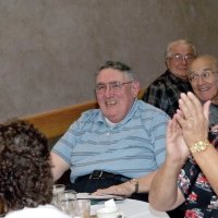 11/29/09 - 31st Annual Guilio Francesconi Charity Raffle drawing, Italian American Social Club, San Francisco - Handford Clews, center, just after learning he and wife Margot have won the grand prize. Looking on, back left, are George Habeeb, Joe Farrah, and Don Stanaway, with a guest applauding.