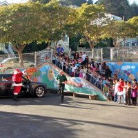 12/18/09 - Christmas with Santa, Mission Education Center, San Francisco - Officer Ignacio “Natcho” Martinez as Santa - Santa waiving to the children and teachers. Aaron Straus taking photos near Santa’s car.