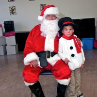 12/18/09 - Christmas with Santa, Mission Education Center, San Francisco - Officer Ignacio “Natcho” Martinez as Santa - Santa with his youngest helper.