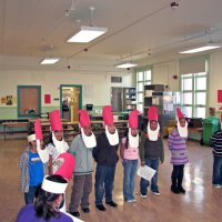 12/18/09 - Christmas with Santa, Mission Education Center, San Francisco - Officer Ignacio “Natcho” Martinez as Santa - A class of Santas singing a song for Santa.