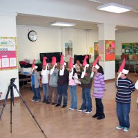 12/18/09 - Christmas with Santa, Mission Education Center, San Francisco - Officer Ignacio “Natcho” Martinez as Santa - A class of Santas singing a song for Santa.