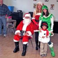 12/18/09 - Christmas with Santa, Mission Education Center, San Francisco - Officer Ignacio “Natcho” Martinez as Santa - Al Gentile looks on as Santa and his helpers pose for a quick photo.