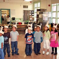 12/18/09 - Christmas with Santa, Mission Education Center, San Francisco - Officer Ignacio “Natcho” Martinez as Santa - Students quietly singing for Santa.