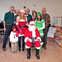 12/18/09 - Christmas with Santa, Mission Education Center, San Francisco - Officer Ignacio “Natcho” Martinez as Santa - L to R, back row: Lyle Workman, Al Gentile, Aaron Straus, Kathy Salet, and Dick Johnson take time to pose with Santa and his helpers.