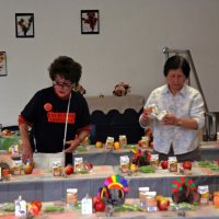 11/20/09 - Thanksgiving Luncheon, Mission Education Center, San Francisco - Emily Powell Palmer, left, and a cafeteria staff person putting on the finishing touches.