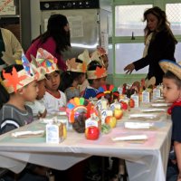 11/20/09 - Thanksgiving Luncheon, Mission Education Center, San Francisco - Students quietly waiting for their plates to arrive; Emily & Joe Farrah back left.