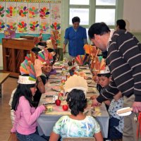 11/20/09 - Thanksgiving Luncheon, Mission Education Center, San Francisco - A teacher explaining what’s in the bags to his students - celery.