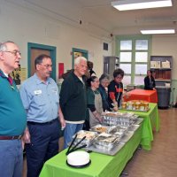 11/20/09 - Thanksgiving Luncheon, Mission Education Center, San Francisco - L to R: Aaron Straus, George Salet, Al Gentile, staff, Emily Farrah, and Emily Powell Palmer; Dick & Diane Johnson behind in doorway; Joe Farrah, far right.