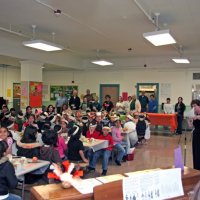 11/20/09 - Thanksgiving Luncheon, Mission Education Center, San Francisco - Principal Debbie Molof making her remarks - back of the room, L to R: George Salet, Al Gentile, staff, Dick Johnson, Emily Farrah, Emily Powell Palmer, Bre Jones, staff, Joe Farrah, Aaron Straus, and staff.