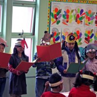 11/20/09 - Thanksgiving Luncheon, Mission Education Center, San Francisco - A class singing a song for the crowd.