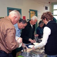 11/20/09 - Thanksgiving Luncheon, Mission Education Center, San Francisco - Preparing plates for the students. L to R, near side: Dick & Diane Johnson; far side: George Salet, Al Gentile, Emily Farrah, and Aaron Straus (behind Diane).