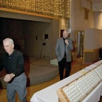 11/28/10 - 32nd Annual Giulio Francesconi Charity Raffle - Upstairs Ballroom, Italian American Social Club, San Francisco - Charlie Bottarini, left, walking toward the drawing drum, and Dick Johnson announcing that ticket holders can place their numbered balls into the drawing drum.