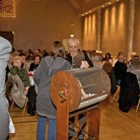 11/28/10 - 32nd Annual Giulio Francesconi Charity Raffle - Upstairs Ballroom, Italian American Social Club, San Francisco - Dick Johnson looks on as Bre Jones draws another winner while Charlie Bottarini holds the door open.