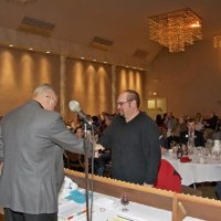 11/28/10 - 32nd Annual Giulio Francesconi Charity Raffle - Upstairs Ballroom, Italian American Social Club, San Francisco - Dick Johnson congratulates a winner while making sure of the numbers; Bre Jones is just over Dick’s arm; table to right of winner, l to r: Bill Stipinovich, Kathy & George Salet, and Robert Quinn.