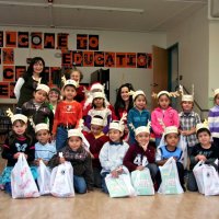 12/17/10 - Annual Christmas with Santa - Mission Education Center, San Francisco - The teacher, her assistant, and students of the kindergarten class pose with Santa and his Elves.