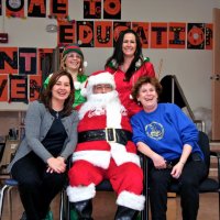 12/17/10 - Annual Christmas with Santa - Mission Education Center, San Francisco - Principal Deborah Molof, right, and her assistant, left, take time to pose with Santa and his Elves.