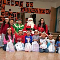 12/17/10 - Annual Christmas with Santa - Mission Education Center, San Francisco - The teacher and first grade students pose with Santa and his Elves.